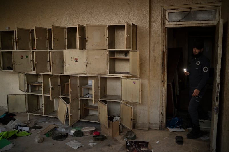 A police officer from Idlib shows a room of a damaged police station in the Bab Touma neighborhood of the Old City of Damascus, Syria (Leo Correa/AP)