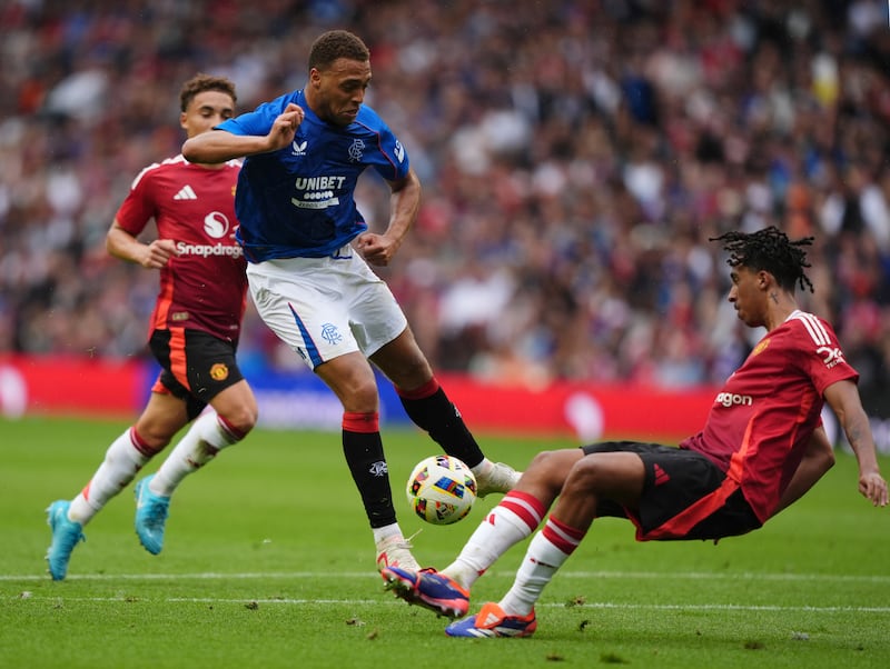 Rangers’ Cyriel Dessers (centre) has his shot blocked by Leny Yoro