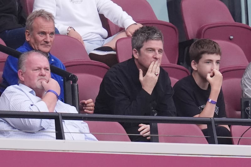 Noel Gallagher (centre) watches from the stands on the day Oasis’ comeback tour tickets went on sale