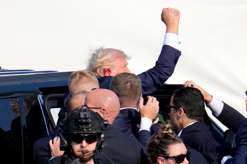 Republican presidential candidate former president Donald Trump pumps his fist as he is escorted into a vehicle at a campaign event (AP Photo/Gene J. Puskar, File)