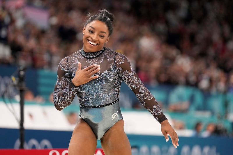 Simone Biles competes on the balance beam during the women’s artistic gymnastics qualification round at the Bercy Arena in Paris (Abbie Parr/AP)