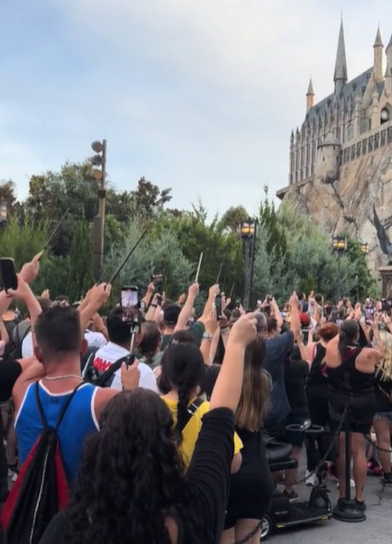 Harry Potter fans raised their wands outside the Hogwarts Castle replica in Florida in a tribute to Dame Maggie Smith