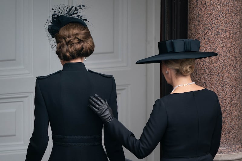 The Duchess of Edinburgh places her hand on the Princess of Wales’s back as they leave the balcony at the Foreign, Commonwealth and Development Office on Remembrance Sunday