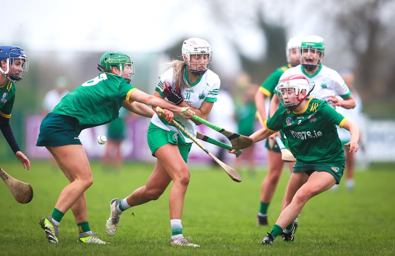 Granemore's Jordan Carr is challenged by Laura McGrath and Zoe Katus of Knockananna