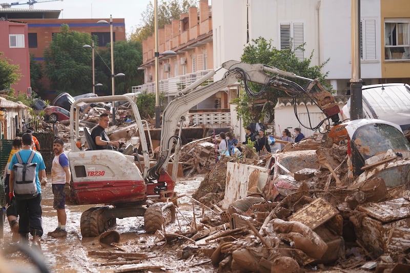 A small crane works to clear away debris during the clean-up in Massanassa, just outside of Valencia