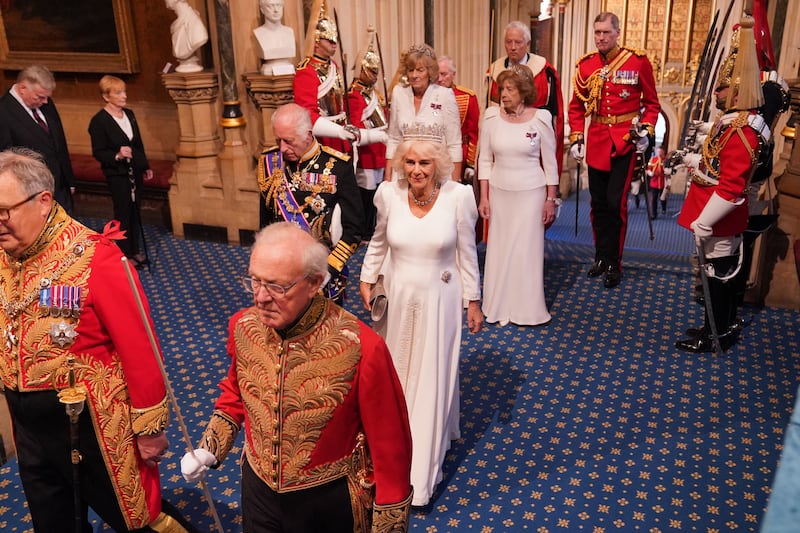 The King and Queen, followed by the Marchioness of Lansdowne and Lady Sarah Keswick, arrive for the State Opening of Parliament