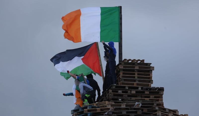 A Palestinian flag atop a bonfire in Belfast's Sandy Row alongside a tricolour.