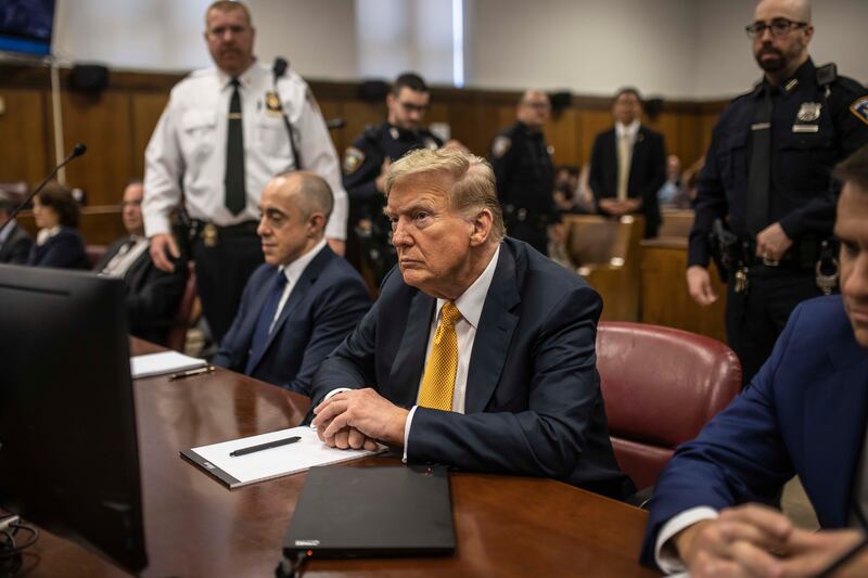 Donald Trump sits between his lawyers Emil Bove, left, and Todd Blanche, right, before the start of the day’s proceedings in Manhattan Criminal Court (Dave Sanders/The New York Times via AP, Pool)