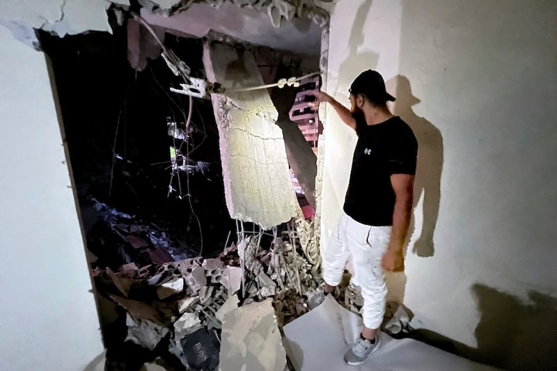 A man inspects a destroyed building that was hit by an Israeli airstrike in the southern suburbs of Beirut, Lebanon (Hussein Malla/AP)