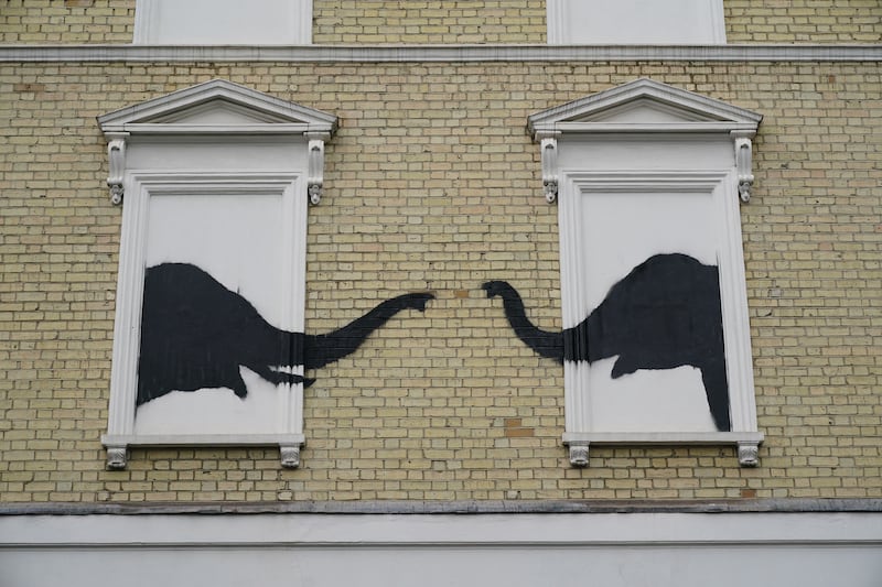 A Banksy artwork depicting two elephants poking their heads out of blocked out windows was unveiled on the side of a building in Chelsea on Tuesday