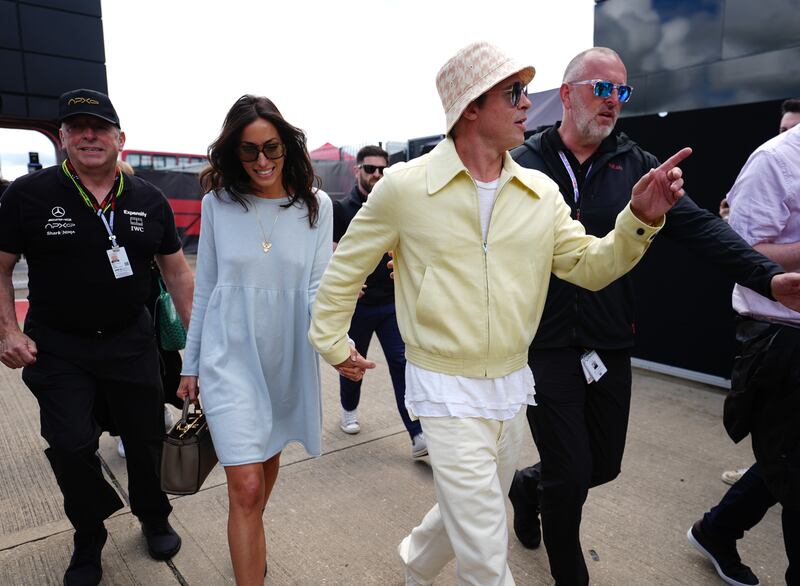 The pair smiled in their sunny ensembles despite the cloudy weather