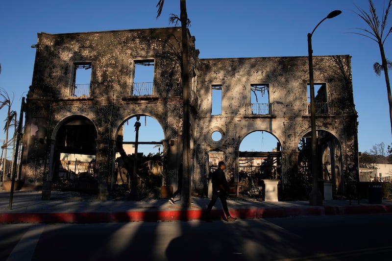 The front face of a building is all that is left standing in the aftermath of the Palisades Fire (John Locher/AP)