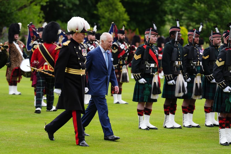 Charles inspects the guard of honour during the Ceremony of the Keys at the Palace of Holyroodhouse