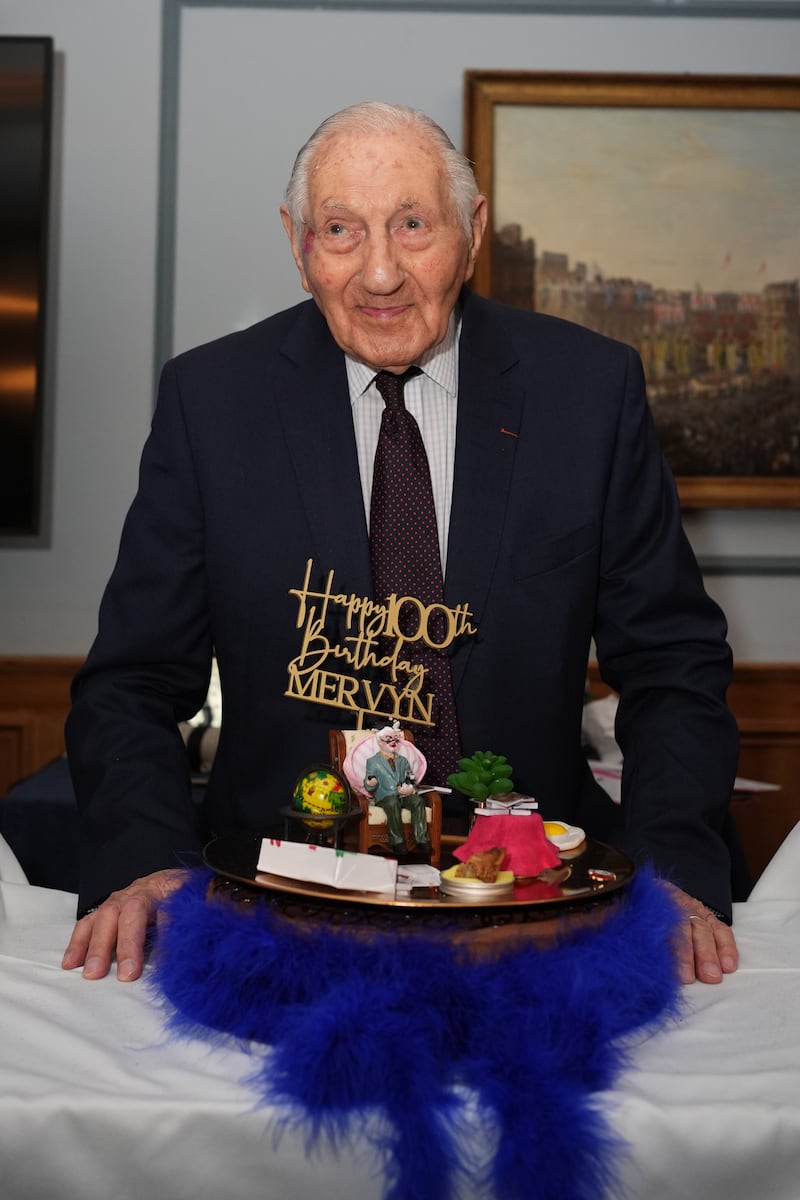 Mervyn Kersh with his cake during a surprise party for his 100th birthday at the Union Jack Club in London