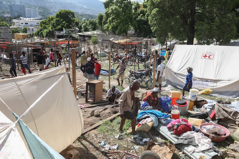 Residents of the Nazon neighbourhood displaced by gang violence construct a tent encampment in Port-au-Prince, Haiti (Odelyn Joseph/AP)