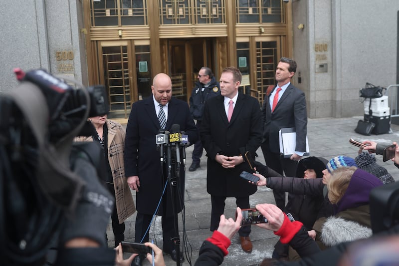 Giuliani’s lawyer, Joseph Cammarata, left, reads a statement alongside Giuliani’s son, Andrew, outside the court (Heather Khalifa/AP)