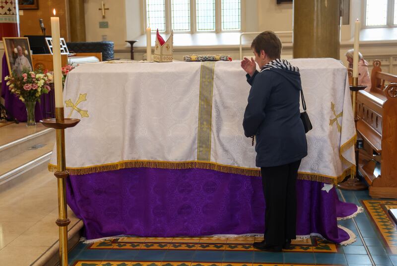 The remains of Archbishop Noel Treanor  at St Peter’s Cathedral on Monday for those who wish to pay their respects, ahead of the Funeral on Tuesday.
PICTURE COLM LENAGHAN