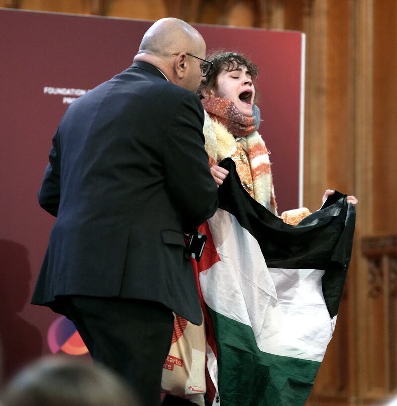 A pro-Palestinian protester is removed after interrupting shadow foreign secretary David Lammy during his speech to the Fabian Society conference in central London