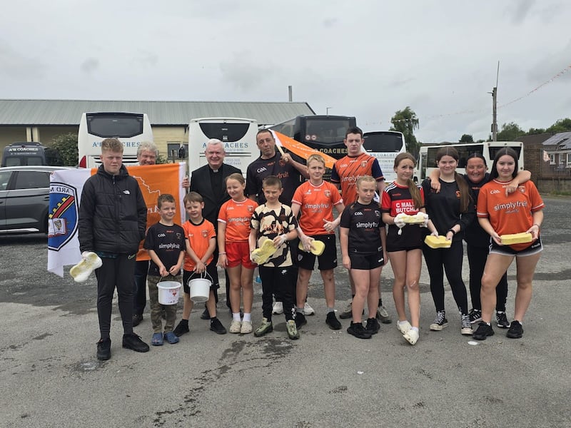 Members of Drumcree Centre pictured with clergymen at a car wash on Sunday to raise money that helped pay for the bunting on the Garvaghey Road in Portadown