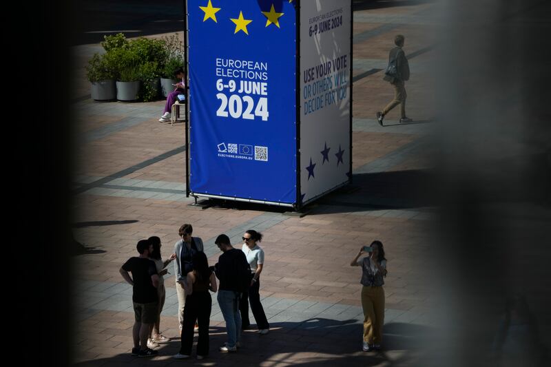 People stand on the outside esplanade during a voting event at the European Parliament in Brussels (Virginia Mayo/AP)
