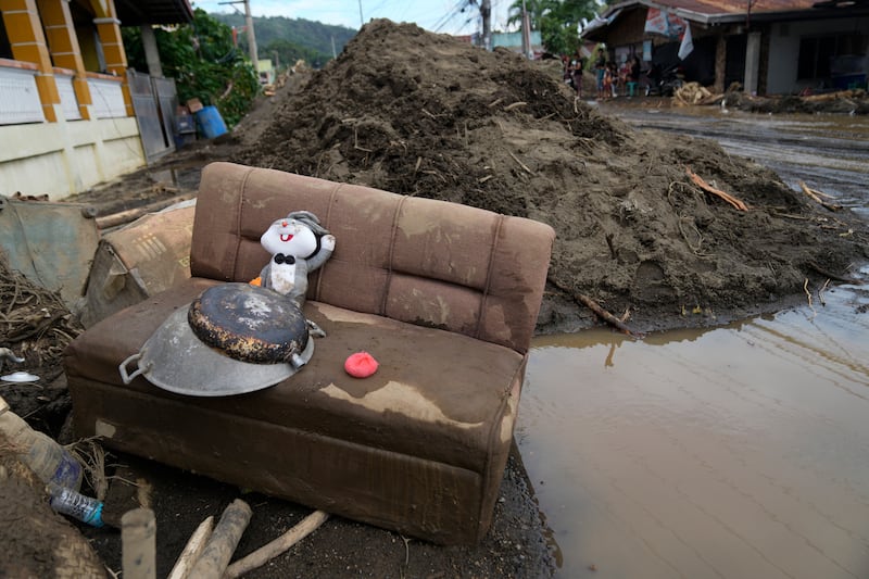 A rabbit doll sits on a mud-covered sofa after a landslide triggered by Tropical Storm Trami struck homes in Talisay, Batangas province (AP Photo/Aaron Favila)