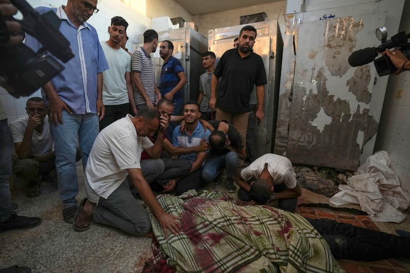 Palestinians mourn the victims of an Israeli airstrike in Deir al Balah (Abdel Kareem Hana/AP)