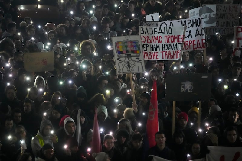 A young student protester was hit by a car and seriously wounded in Belgrade (Darko Vojinovic/AP)