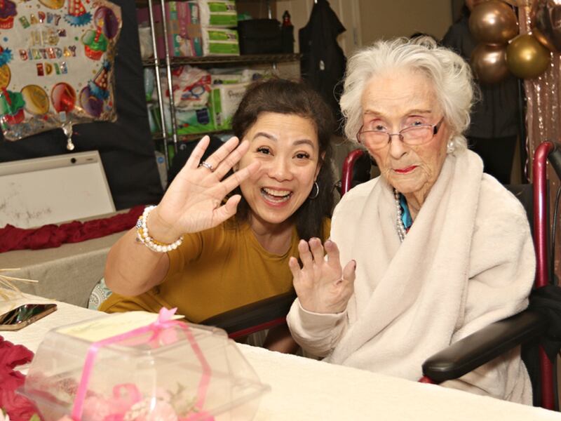 Edie Ceccarelli celebrates her 116th birthday with Holy Spirit Care Home's Perla Gonzalez in Willits, California.