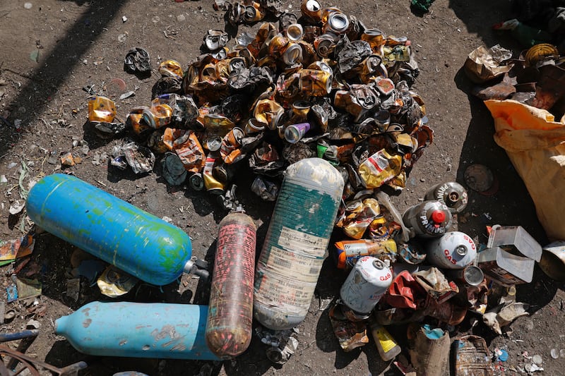 Used oxygen cylinders and beer cans collected en route to Mount Everest (Sanjog Manandhar/AP)