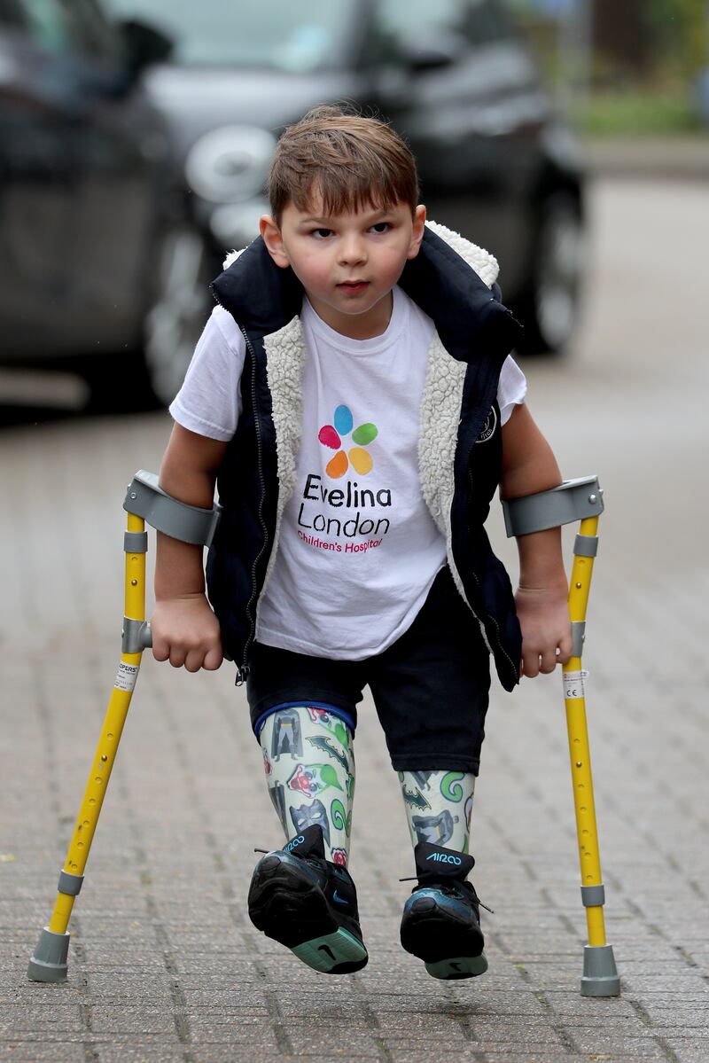 Tony Hudgell, then aged just five, takes the final steps in his walk that raised more than £1 million for the hospital which has cared for him since he was four-months-old