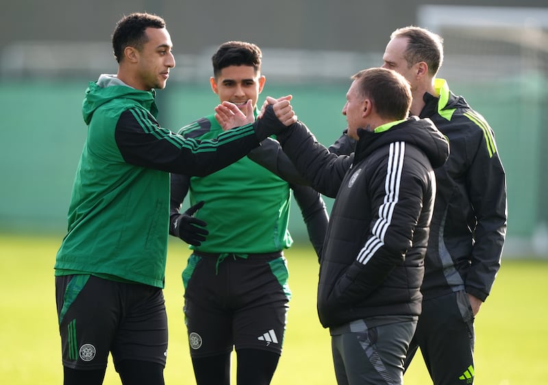 Adam Idah and Luis Palma are greeted by Rodgers during a training session