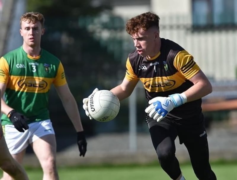 Paddy McAteer carrying the ball out of defence wearing a black Mullaghbawn Cúchulainn's jersey passing a  player wearing number 3 for Mullaghbawn Cúchulainn's