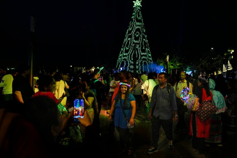 People celebrate New Year’s eve at a promenade in Mumbai, India