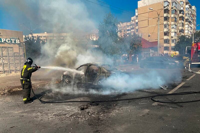 Firefighters extinguish a burning car in the courtyard of an apartment building after a missile attack by Ukraine in Belgorod, Russia (Belgorod Region Governor Vyacheslav Gladkov/Telegram/AP)