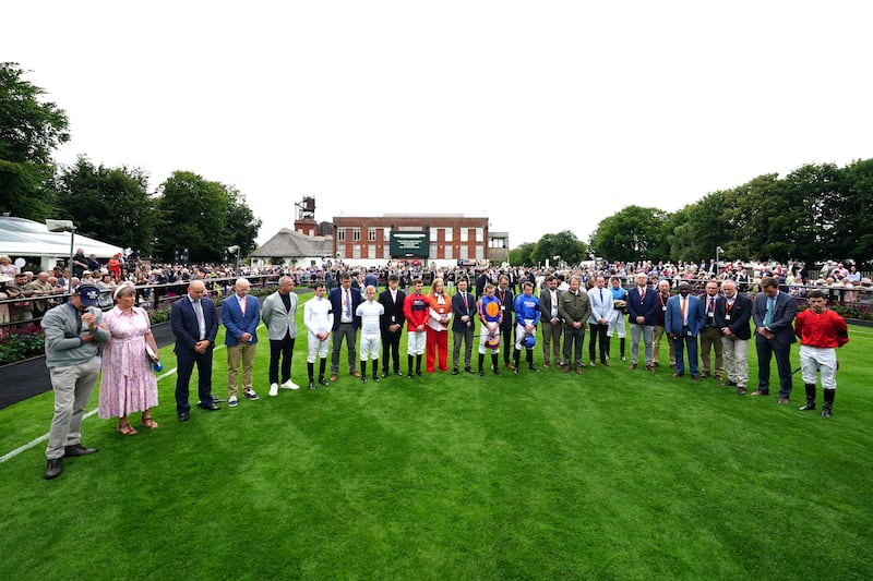 A minute’s silence being observed for Carol, Louise and Hannah Hunt ahead of Ladies Day during the July Festival 2024 at Newmarket Racecourse