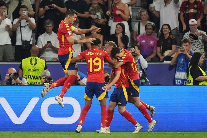 Spain’s Dani Olmo, centre right, celebrates with team-mates after scoring his side’s second goal against France