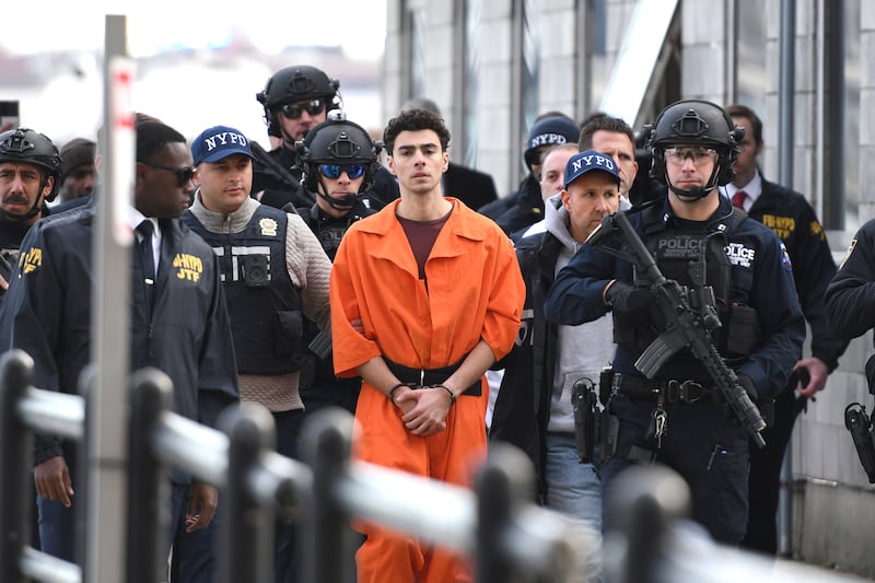 Luigi Mangione, a suspect in the fatal shooting of UnitedHealthcare boss Brian Thompson, is escorted by police. (AP/Pamela Smith)