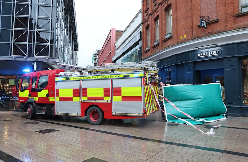 Emergency Services at the scene at Castle Lane in Belfast on Sunday after scaffolding became unsafe. A member of the public has been struck by falling debris and is being treated at the scene by emergency services in attendance. 
PICTURE COLM LENAGHAN