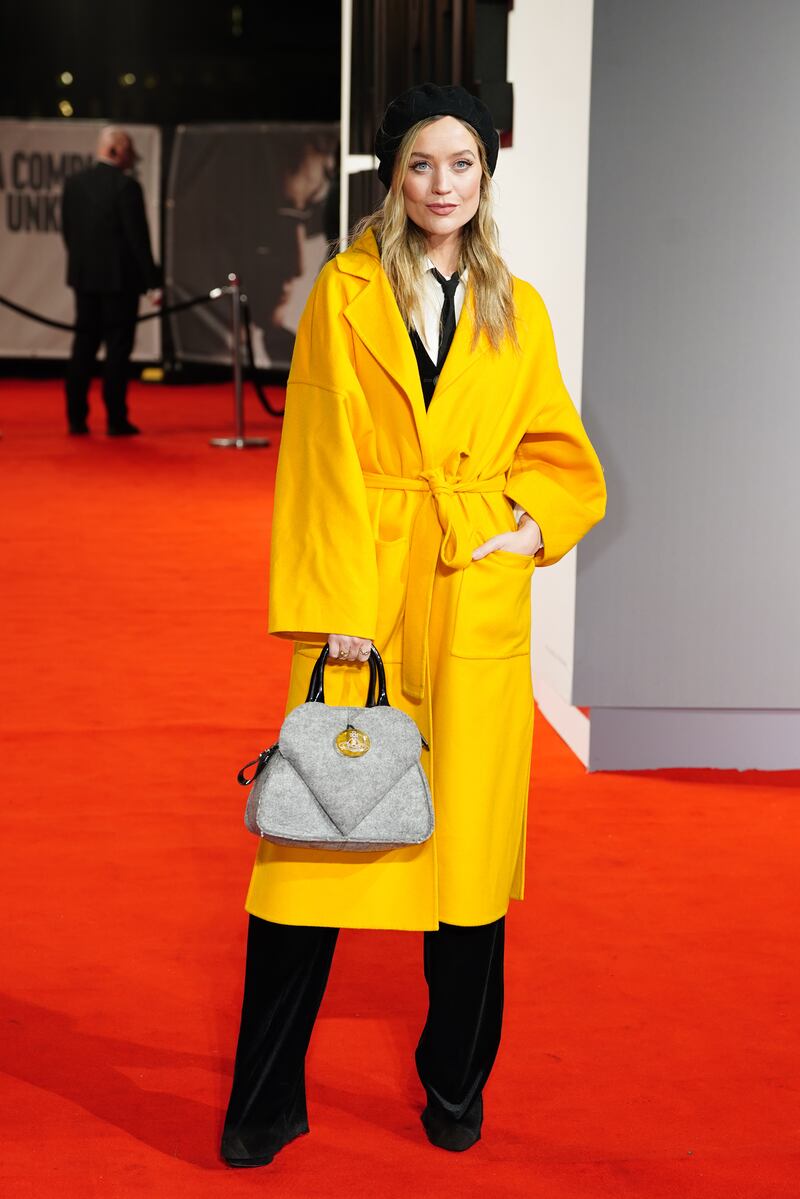 Laura Whitmore wore a three piece suit and a yellow trench