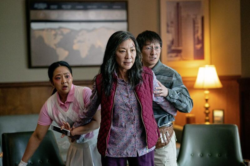 Everything Everywhere All At Once: Stephanie Hsu as Joy Wang, Michelle Yeoh as Evelyn Quan Wang and Ke Huy Quan as Waymond Wang 