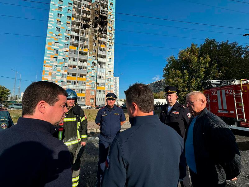 Russian officials outside a damaged multi-storey residential building in Ramenskoye, outside Moscow, following an alleged Ukrainian drone attack (Moscow region governor Andrei Vorobyev official telegram channel via AP)