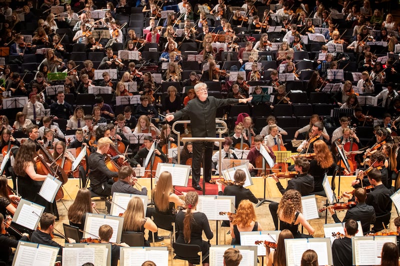 Sir James MacMillan conducts around 1,200 school pupils in one of the largest orchestras ever assembled in Scotland at a concert in Glasgow in June 2019