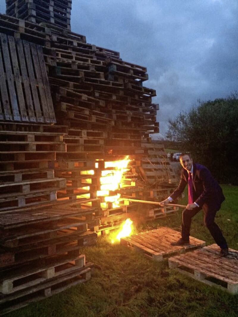 DUP communities minister Paul Givan lights an Eleventh Night bonfire in 2016 