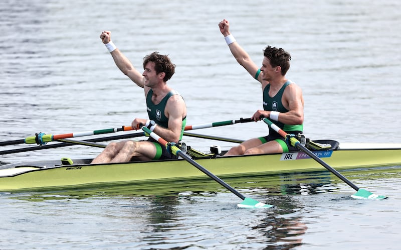 Fintan McCarthy and Paul O'Donovan salute the Irish support after landing gold in Paris on Friday. Picture by Francois Nel/Getty Images