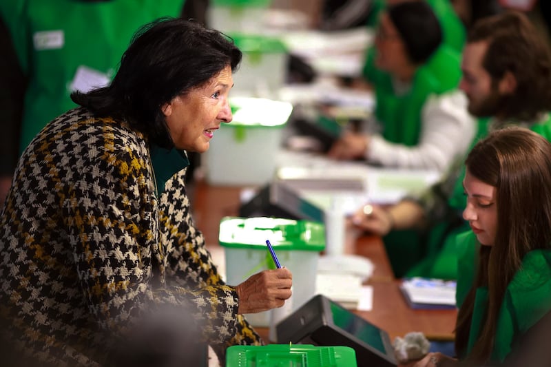 Georgian President Salome Zourabichvili gets her ballot at a polling station during the parliamentary election in Tbilisi, Georgia (Shakh Aivazov/AP)