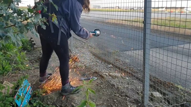 Activists appeared to cut a hole in the airport’s metal fencing