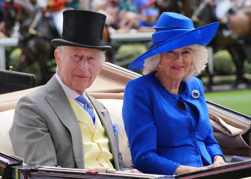 The Queen, dressed in a royal blue hat and outfit, arrive on day one of Royal Ascot