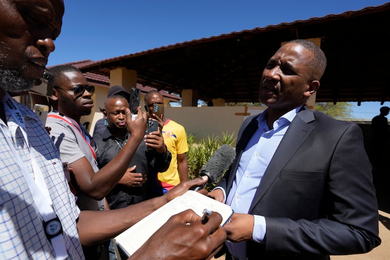 Umbrella for Democratic Change (UDC) presidential candidate Duma Boko speaks to journalist after casting his vote during the elections in Gaborone (Themba Hadebe/AP)