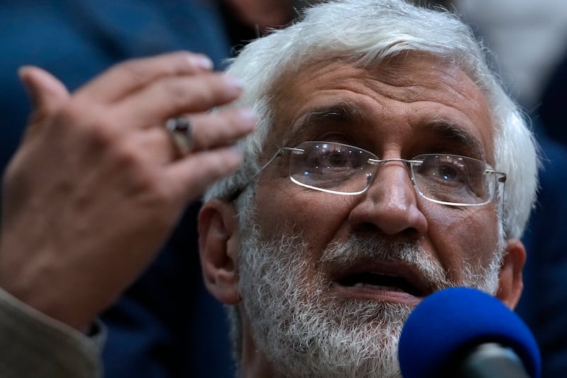 Iranian presidential candidate Saeed Jalili, a hard-line former nuclear negotiator, speaks to a group of athlete supporters during a campaign stop at a sports hall in Tehran (Vahid Salemi/AP)