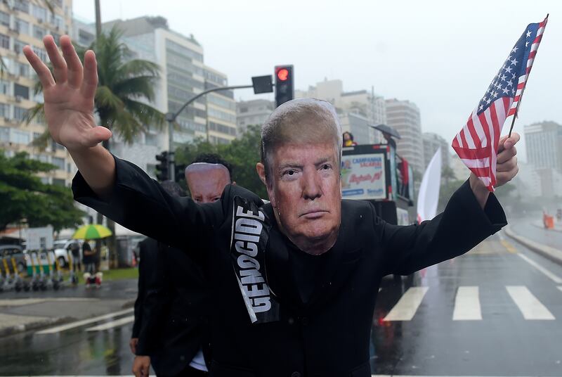 A demonstrator wearing a mask depicting US President-elect Donald Trump takes part in a protest before the G20 Summit in Rio de Janeiro, Brazil, in November (Dhavid Normando/AP)